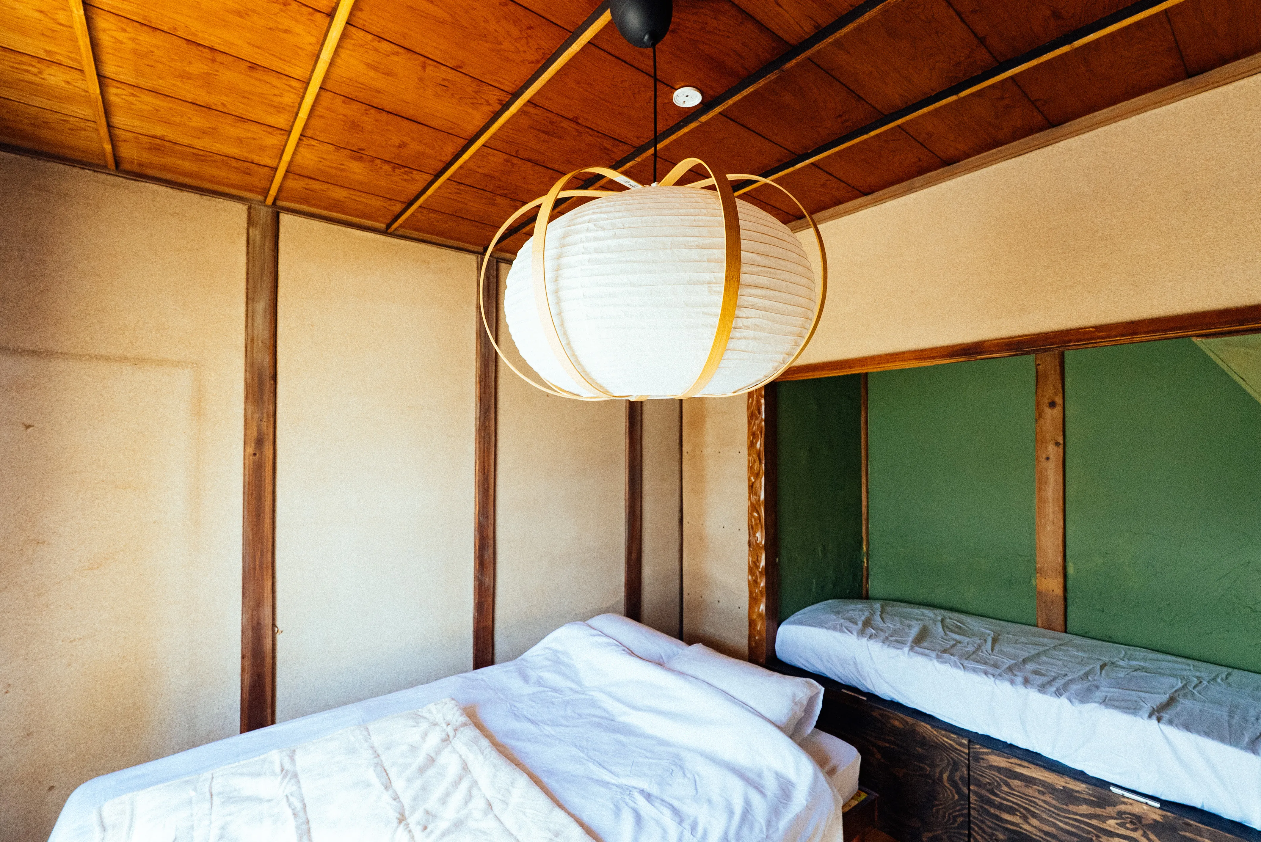 Room A bed area with paper lantern lighting